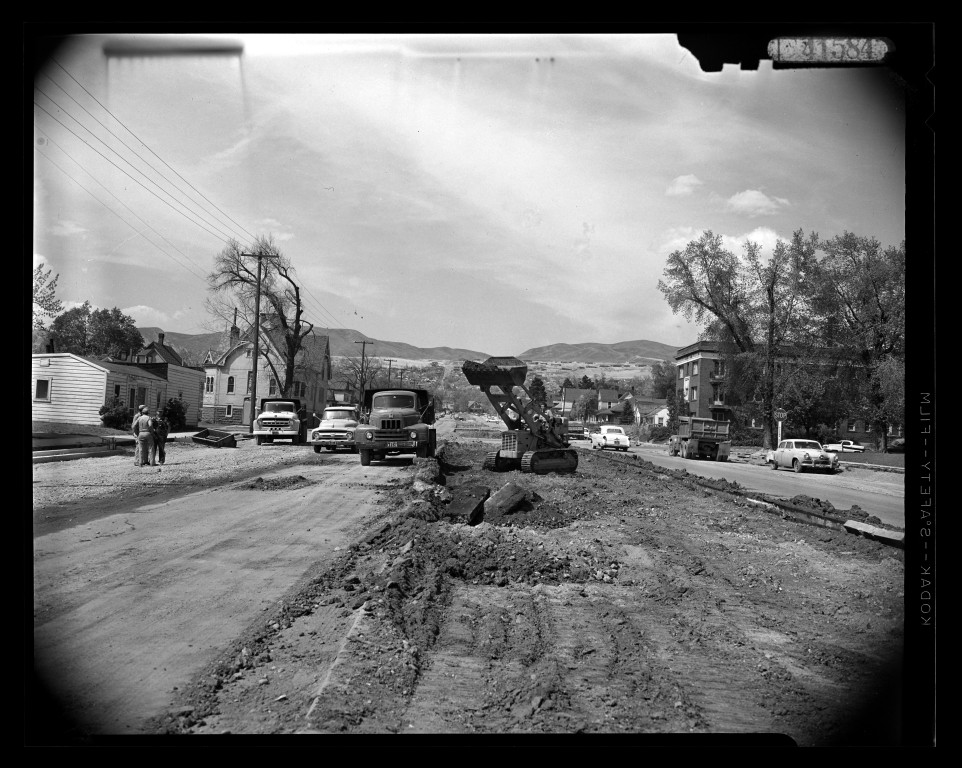 Excavator, trucks and workers rebuilding 700 East at 300 South in 1956